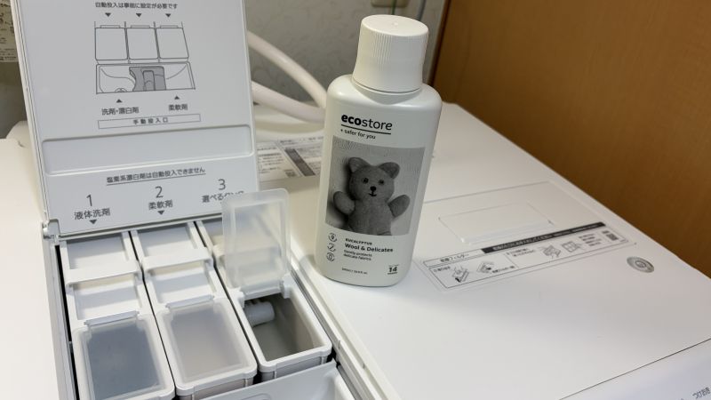パナソニック洗濯機の自動投入タンクの横に置かれた、エコストア（ecostore）のおしゃれな洗濯洗剤ボトル。